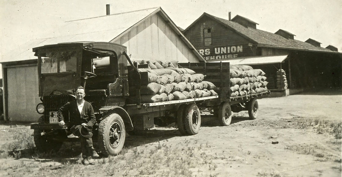 Black and white photo of first feed truck in 1920