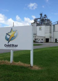 A large sign outside, in front of a mill, that shows the Gold Star logo